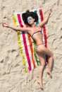 Relaxed girl in bikini on the sand beach