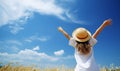 Relaxed girl breathing fresh air raising arms over blue sky at summer. Royalty Free Stock Photo