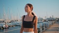 Relaxed girl going harbor enjoying evening sunlight close up. Chic woman walking