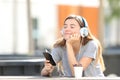 Relaxed girl listening to music sitting in a park Royalty Free Stock Photo