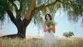 Relaxed girl posing camomiles flowers at garden. Romantic woman holding bouquet Royalty Free Stock Photo