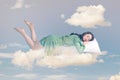 Young relax woman in dress sleeping on pillow in the sky.