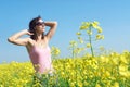 Relaxed girl on sunny flower field.