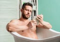 Relaxed guy reading book while relaxing in hot bath. Relax at home. Total relaxation. Personal hygiene. Nervous system Royalty Free Stock Photo