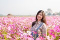 Relaxed happy and carefree pretty asian woman at flower garden in Chiangmai, concept photo of travel and freedom