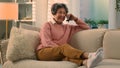 Relaxed happy laughing old woman on cozy sofa talking on smartphone laugh discuss funny news carefree smiling senior Royalty Free Stock Photo