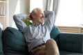 Relaxed happy mature old man enjoying free lazy weekend time. Royalty Free Stock Photo