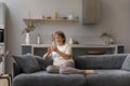 Relaxed happy old woman using cellphone at home. Royalty Free Stock Photo