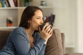 Relaxed happy woman drinking coffee at home Royalty Free Stock Photo