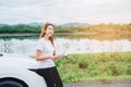 Relaxed happy woman traveler on summer roadtrip vacation on hatchback car Royalty Free Stock Photo
