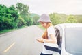 Relaxed happy woman traveler on summer roadtrip vacation on hatchback car Royalty Free Stock Photo