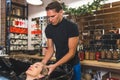 Relaxed happy young woman having salon hair wash and head massage done by professional male hairstylist. Hairdresser Royalty Free Stock Photo