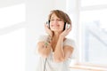 Relaxed happy young woman listening to music using earphones Royalty Free Stock Photo