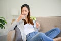Relaxed and healthy Asian female drinking water and eating her healthy salad Royalty Free Stock Photo