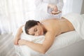 Relaxed indian female getting salt scrub beauty treatment in the health spa Royalty Free Stock Photo