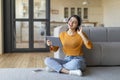 Relaxed indian lady in headphones listening music on digital tablet at home Royalty Free Stock Photo