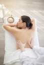 Relaxed indian woman enjoying back massage in spa salon, top view Royalty Free Stock Photo