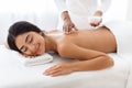 Relaxed indian woman having massage with sea salt in spa Royalty Free Stock Photo