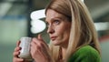 Relaxed lady drinking tea cup in late office portrait. Thoughtful woman resting Royalty Free Stock Photo