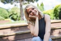 Relaxed lady in the park looking away and smiling