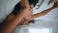 Relaxed lady stretching at morning bed closeup. African serene girl waking up