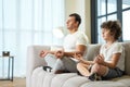 Peaceful vibes. Relaxed latin middle aged father and his son meditating together on a couch at home