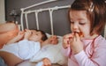 Relaxed little girl eating cookies over the bed Royalty Free Stock Photo