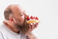 Relaxed male eating tasty cake