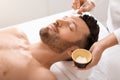 Relaxed man attending cosmetologist or spa salon Royalty Free Stock Photo
