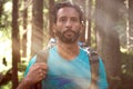 Relaxed man with backpack portrait on hiking trail path in forest woods during sunny day.Group of friends people summer Royalty Free Stock Photo