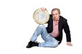 Relaxed man holding an euro coin Royalty Free Stock Photo