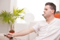 Relaxed man with remote command watching television Royalty Free Stock Photo