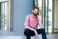 Relaxed man sitting outside talking on mobile phone Royalty Free Stock Photo