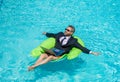 relaxed man trader work and relax. man trader work and relax in swimming pool.