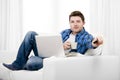 Relaxed man using Computer at home switching tv on Royalty Free Stock Photo