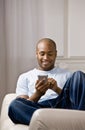 Relaxed man using electronic organizer