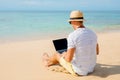 Relaxed man working with laptop on the beach Royalty Free Stock Photo