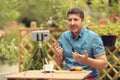 Relaxed manager discussing business strategies with his team on video call. Young casual business owner at a table having a video