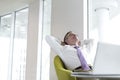 Relaxed mature businessman reclining at lobby Royalty Free Stock Photo
