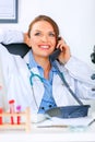 Relaxed medical doctor woman talking on phone