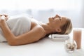 Relaxed Middle Aged Woman Lying On Table In Spa Salon, Side View Royalty Free Stock Photo