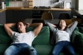 Relaxed millennial couple resting breathing fresh air on comfort