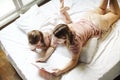 Relaxed mother and little daughter together with book in their hands Royalty Free Stock Photo