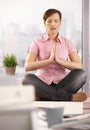 Relaxed office worker meditating Royalty Free Stock Photo