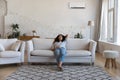 Relaxed peaceful happy renter woman resting on white soft couch Royalty Free Stock Photo