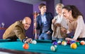 Relaxed people playing billiard and darts