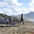Relaxed people on the Sabaudia beach for the summer holidays. The Circeo Mountain on the background. Sabaudia, Lazio, Italy