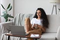 Relaxed young woman watching movie on laptop Royalty Free Stock Photo