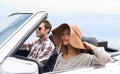 Relaxed road trip. a young couple enjoying a drive in a convertible.