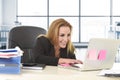 Relaxed 40s woman with blond hair smiling confident sitting on office chair working at laptop computer Royalty Free Stock Photo